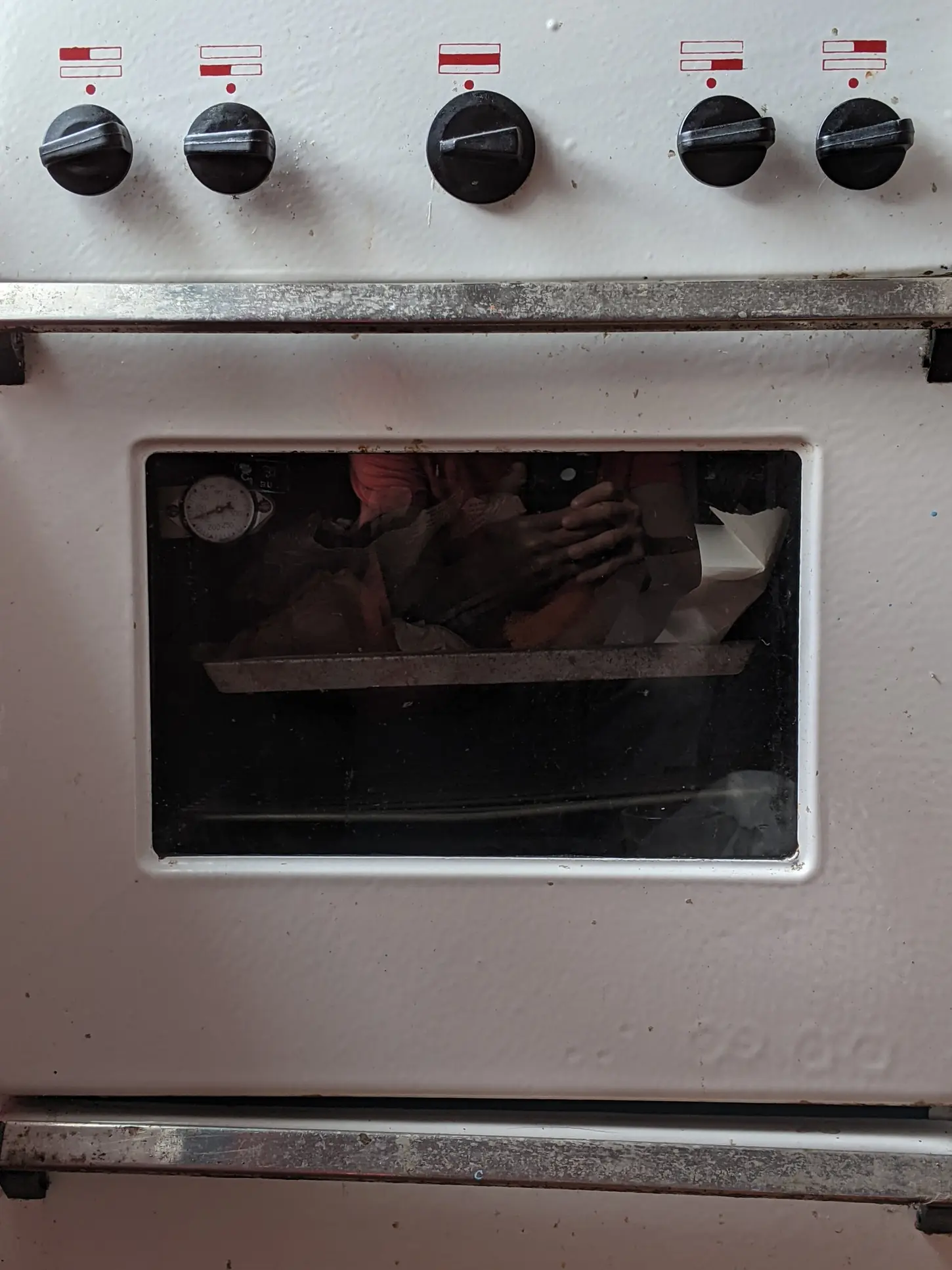 Close-up of oven control dials and temperature gauge